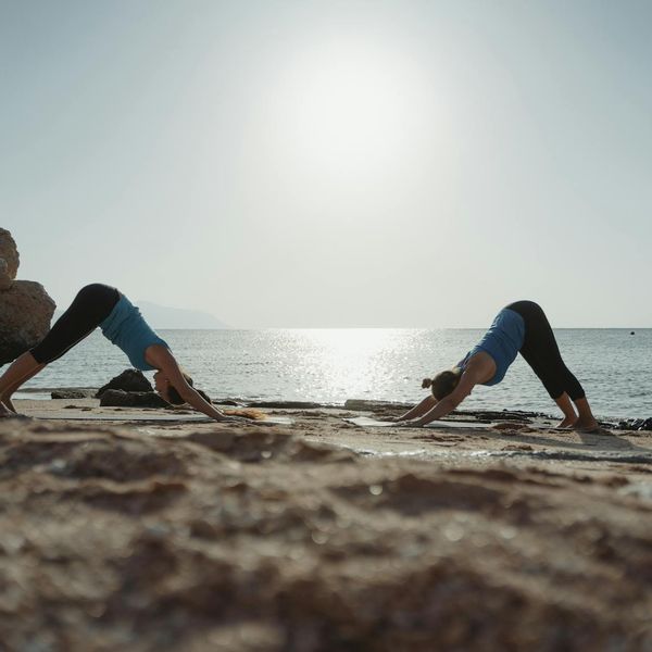 Person stretching outdoors during a beautiful sunrise.